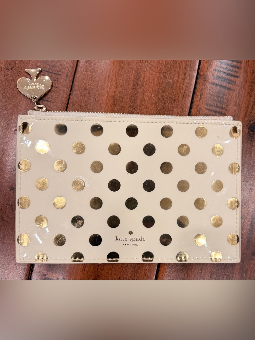 kate spade cream pouch with metallic gold polka dots